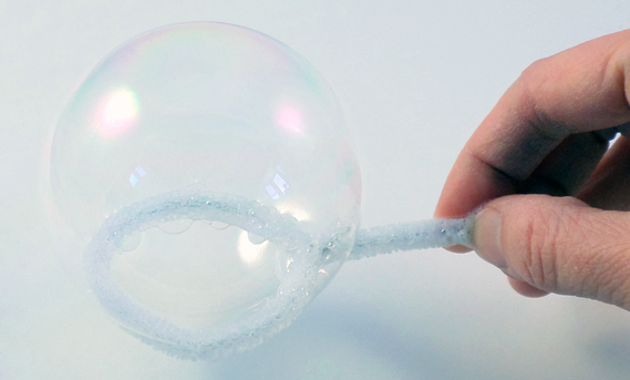 A bubble made from a solution using soap and water on a bubble wand