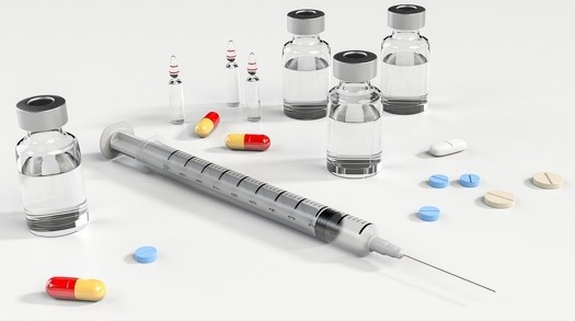 Different forms of mediations such as vials with liquid, pills, and tablets.