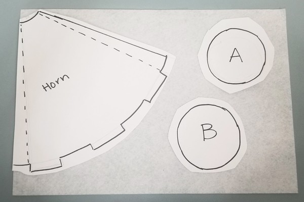 Paper template pieces taped onto felt 