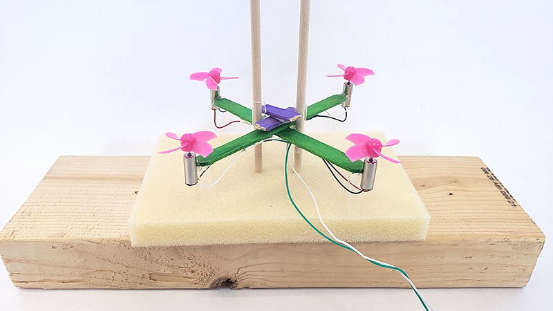 Drone with second popsicle stick added at a right angle to the first one