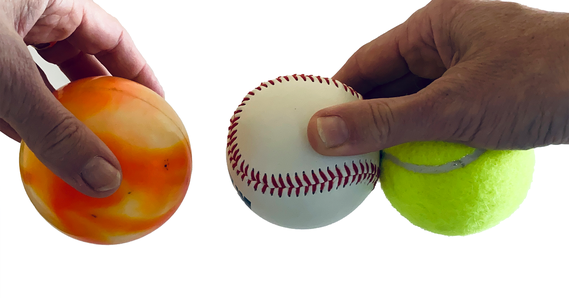 Three balls of similar size but different densities being dropped to see how they fall