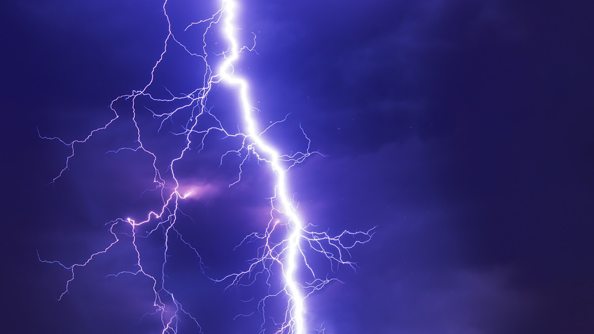 Bright lightning strike on a dark sky.