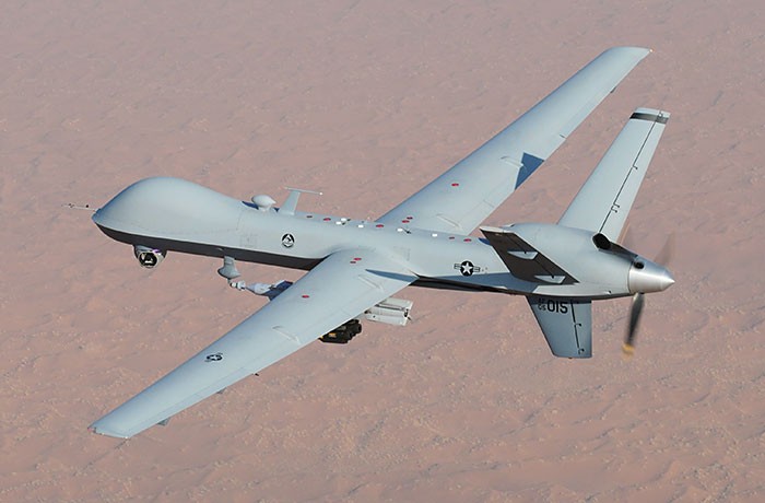 A reaper drone flying in the air.