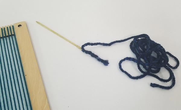 Threaded tapestry needle. 