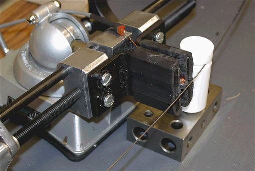 The read and write head touches the wire next to the teflon cylinder