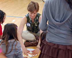 paper airplane hands-on science / Mary Raven demonstrates basic dart folding at science fair