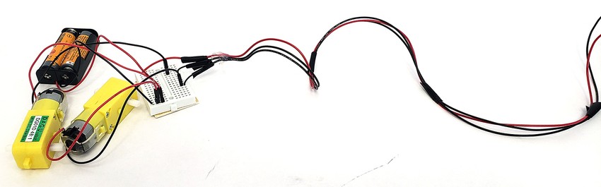 The circuit with the three long wires between breadboards bundled with electrical tape so the do not get tangled.