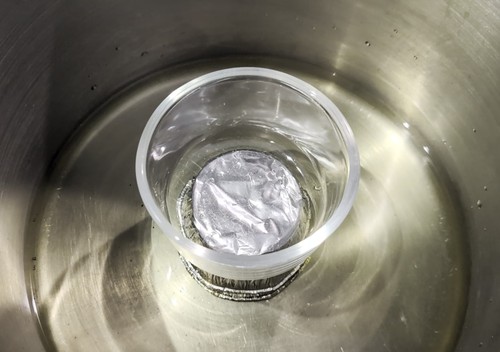 Ramekin with Pyrex collection cup on top inside a large pot