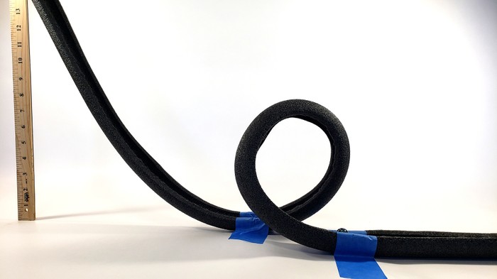 Side view of a loop in a marble roller coaster made from foam pipe insulation