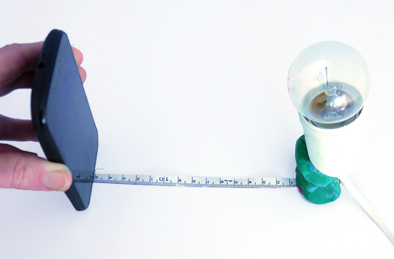 Lightbulb set up in relation to a cellphone with a sensor app to measure intensity with distance