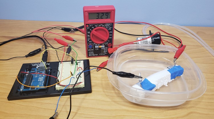 Multimeter connected to the circuit, displaying a value of 3.29 volts. 