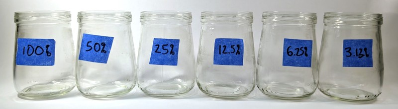 small glass jars labeled with percentages