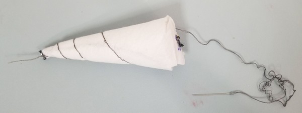 Double-threaded backstitch spiraled around unicorn horn. 