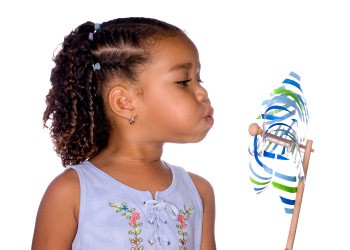 A child blows on a pinwheel