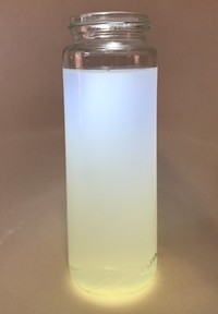 When light is shined vertically through milky-water, the light scatters with blue-white light at the top and yellow-orange light at the bottom.