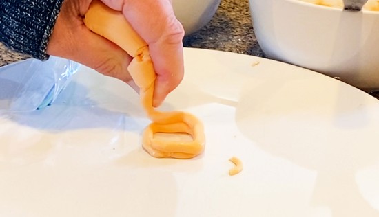 A second layer of icing being laid onto the first layer.  
