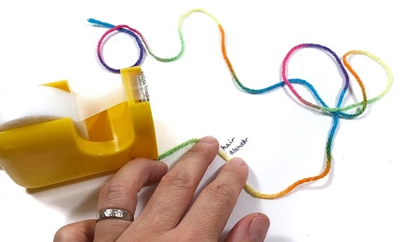 A 1-meter long piece of string with an attached label that says 'hair diameter'