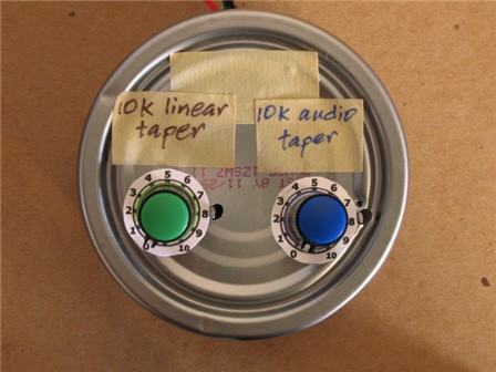 Two potentiometer dials mounted to the bottom of an aluminum can