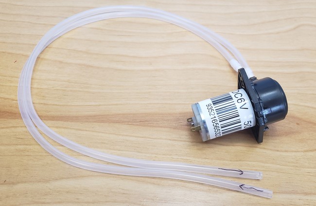 Pump with silicone tubing, with arrows drawn on the tubes to indicate the inlet tube and outlet tube 