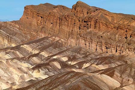 Layers of rock can be seen on the side of a rock face