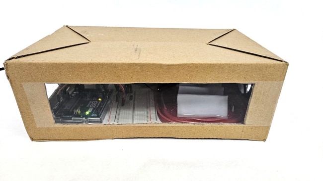 Front view of evaporative cooling setup with viewing window to see Arduino inside