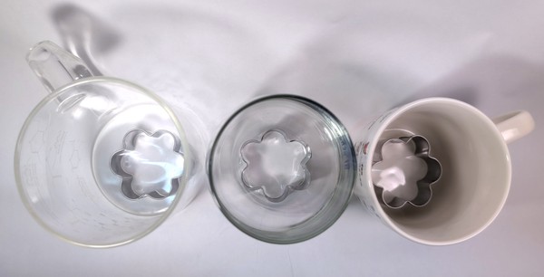 Picture of cookie cutters in three cups, looking from the top.
