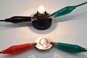 a quarter connected to two resistors