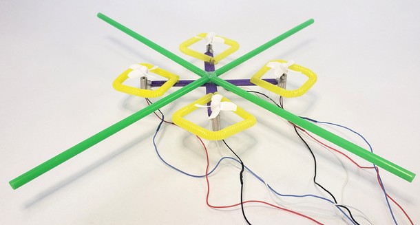 A mini popsicle stick drone with a straw 'roll cage' to prevent propeller damage
