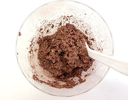 Cup with red-brown, wet, sturdy, mud-like content