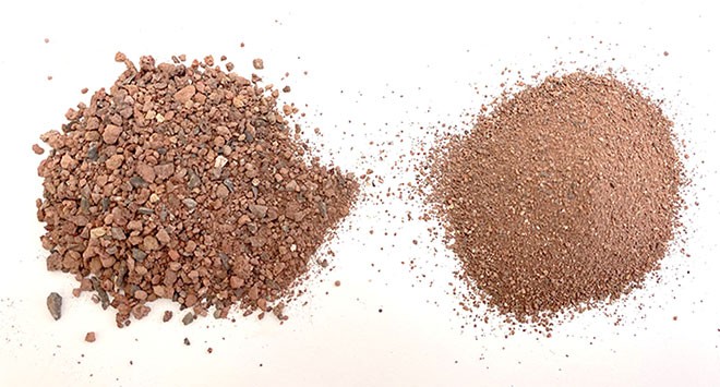 A pile of coarse red gravel next to a pile of very fine red gravel.