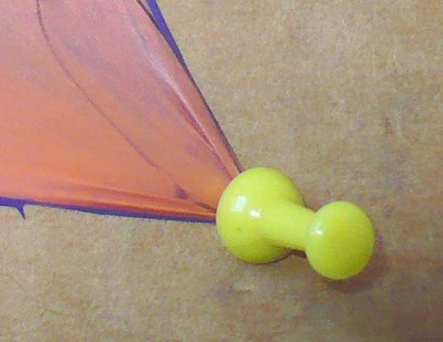 Pinned down balloon where the pin points outward, away from the balloon.