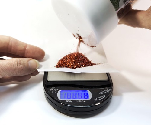Weighing glitter on a digital scale.