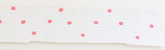 Stack of partially overlapping cards. One red dot is visible in each card. The dots on consecutive cards are on the top, middle, bottom, middle, top, ...