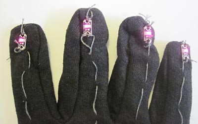 Four red LEDs on the fingertips of a glove
