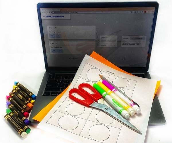 The materials needed to teach an online machine learning tool to distinguish between happy and sad face drawings.