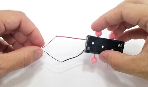 motor and battery wires connected to form a circuit 