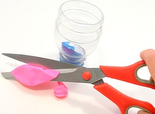  About 1/3 of the top part of a  balloon being cut off.  An upside down bottle with its bottom cut off, and a balloon where the top has been cut off. 
