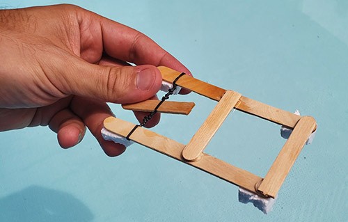 Rubber band paddle boat made from popsicle sticks and bits of foam