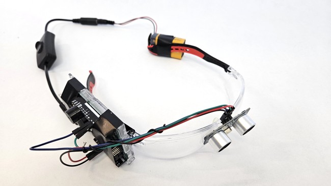 Arduino, ultrasonic sensor, and battery mounted to safety glasses (right view)