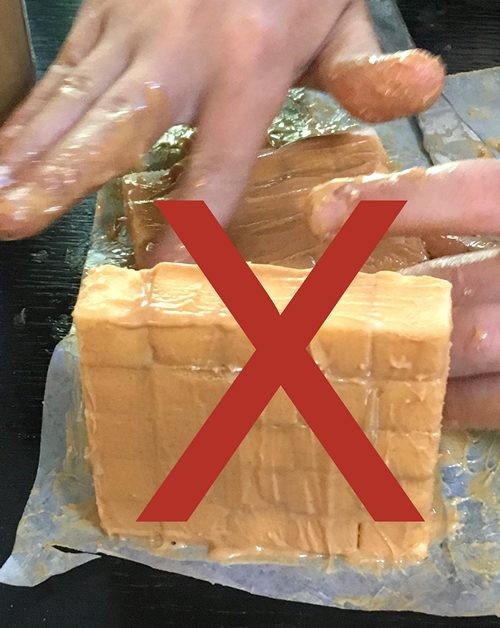 a wall of sugar cubes covered with peanut butter