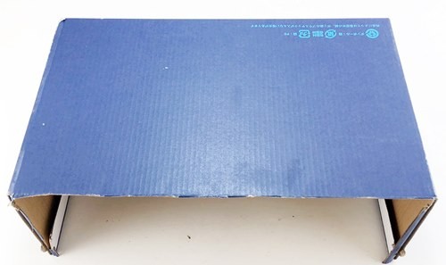 A shoebox with its lid and one of the long side-panels removed.