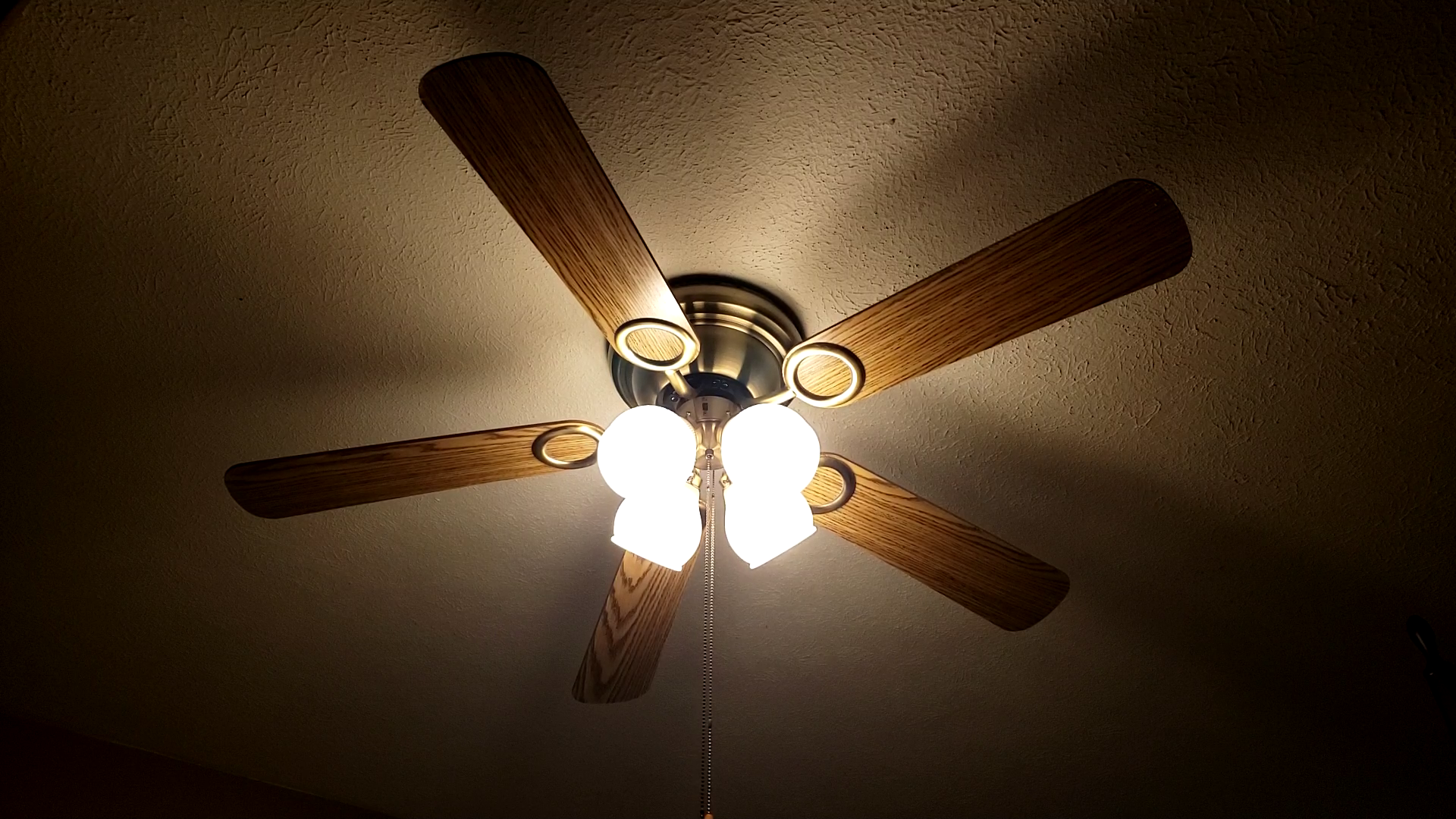 A ceiling fan with five blades.