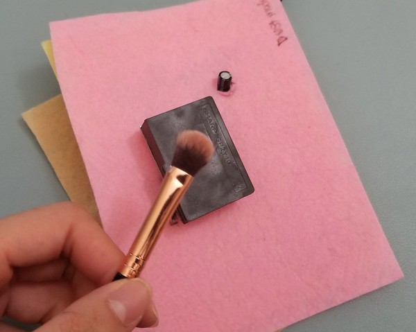 make up brush with powder on dust sensor. 