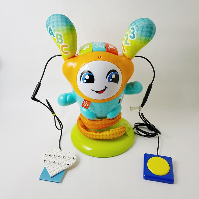 A toy with two external adaptive switches that make it easier to interact with
