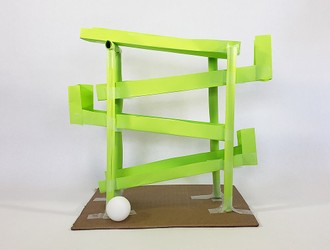 A switchback ball run built from paper and tape
