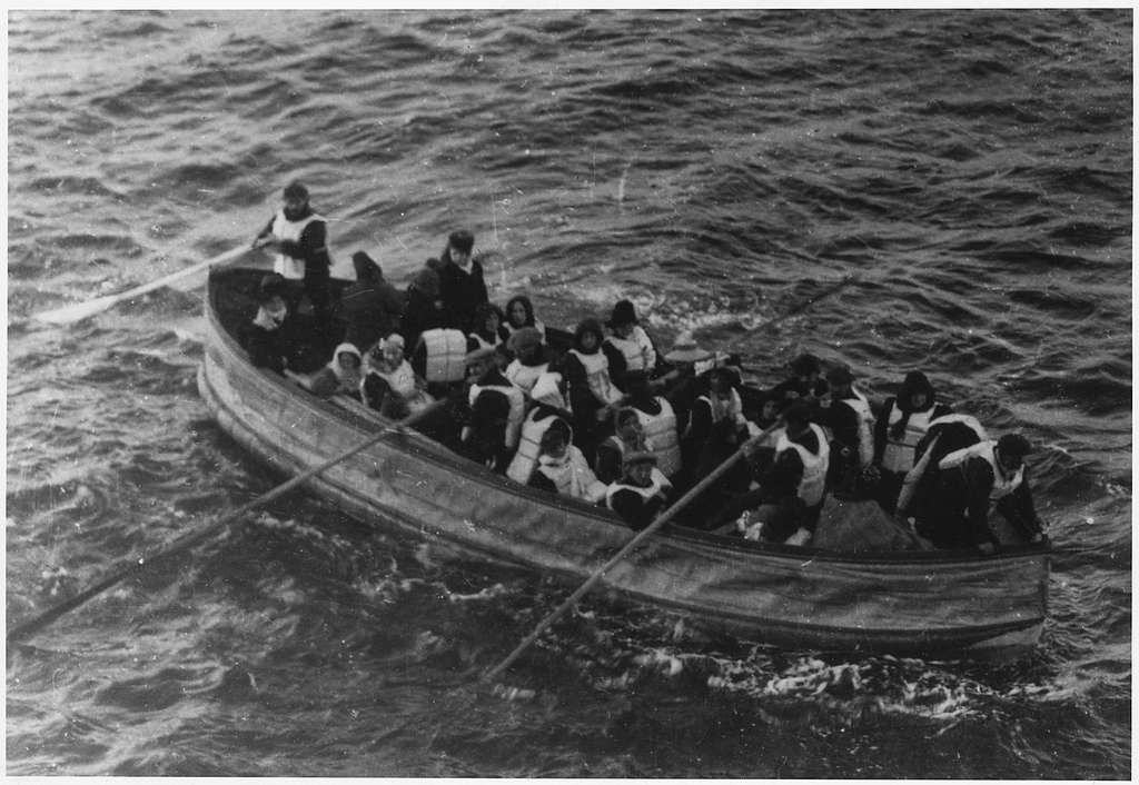 Lifeboat carrying survivors from the Titanic disaster. The lifeboat is filled with individuals who have been rescued from the sinking ship. Some are sitting while others are standing, expressing a range of emotions from shock to hope. 