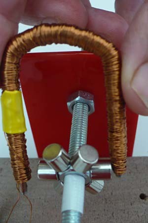 Six magnets on a hex nut fit perfectly between the two prongs of an iron core that has been bent into a U shape
