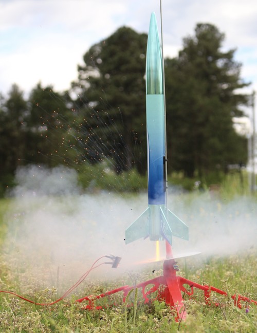 close-up photo of a model rocket at launch