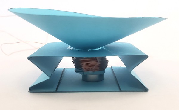 Speaker with magnet inside coil