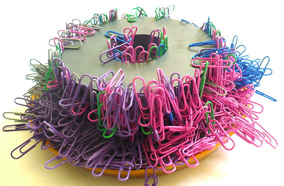 A bunch of paperclips on a magnet for an experiment of magnetism and temperature